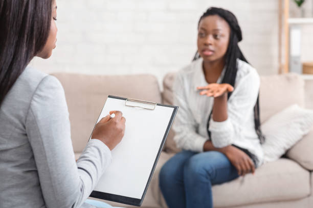 istock Psychologist taking notes during therapy session with her emotional female patient 1193497315
