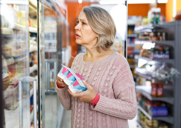 istock Mature woman choosing dairy products 1193497318
