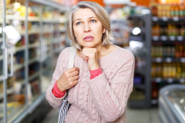istock Pensive female shopping at store 1193497359
