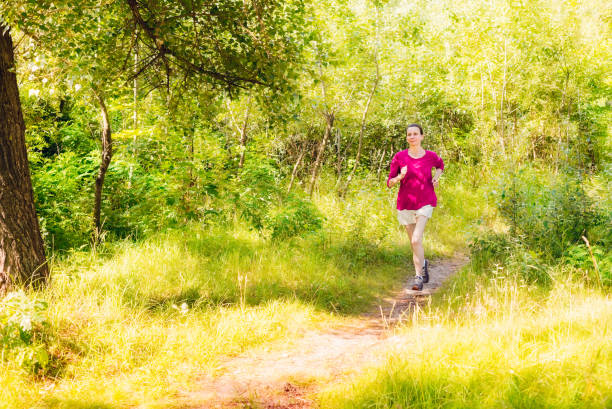 istock Senior Woman Running in the Forest 1193497432