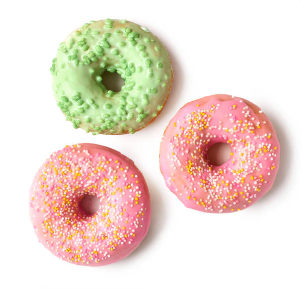 istock freshly baked donuts isolated on white background, top view 1193498666