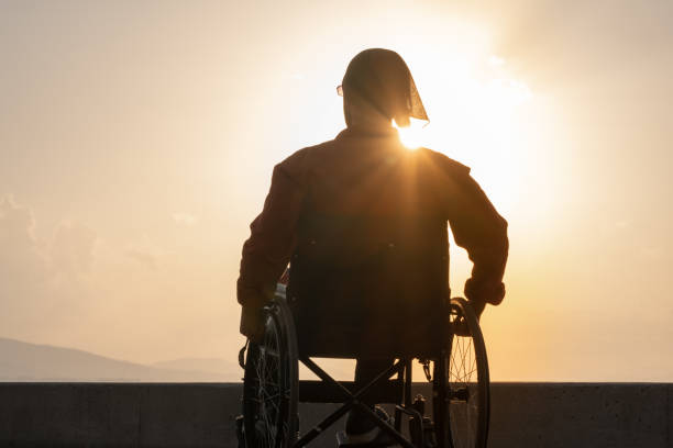istock young man enjoying fresh air on her whellchair 1193503331