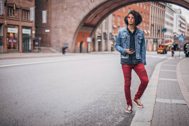 istock Charming man using phone on the street 1193503648