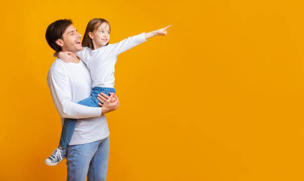 istock Excited little girl pointing her daddy at copy space 1193503790