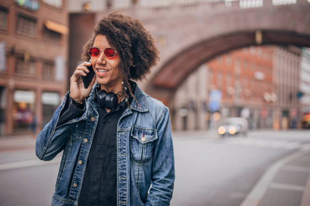 istock Young guy talking on phone on the street 1193503840