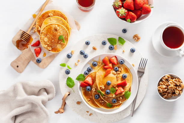 pancakes with blueberry strawberry honey and nuts for breakfast - norway maple imagens e fotografias de stock