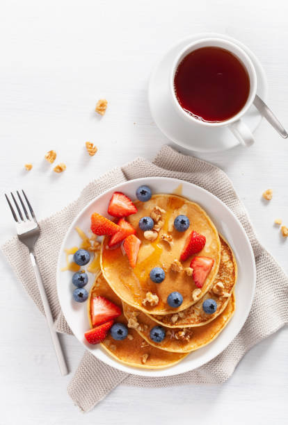 pancakes with blueberry strawberry honey and nuts for breakfast - norway maple imagens e fotografias de stock
