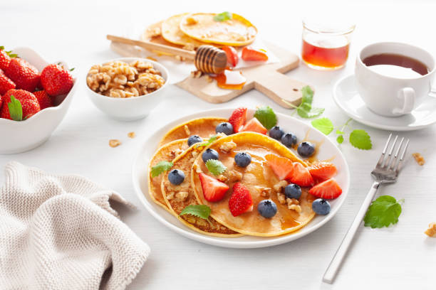 istock pancakes with blueberry strawberry honey and nuts for breakfast 1193506268