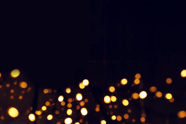 istock holiday garland lights yellow unfocused bokeh illumination frame on black background empty copy space for your text or inscription here 1193506635