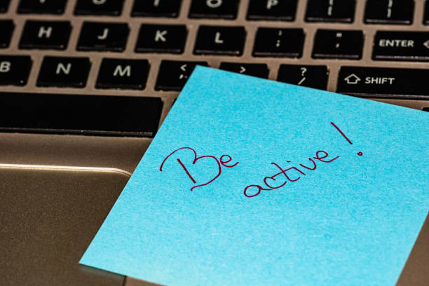 istock Writing on colorful sticky note Be active. Text with Be active on paper. Sticky note, post it on keyboard. 1193506709