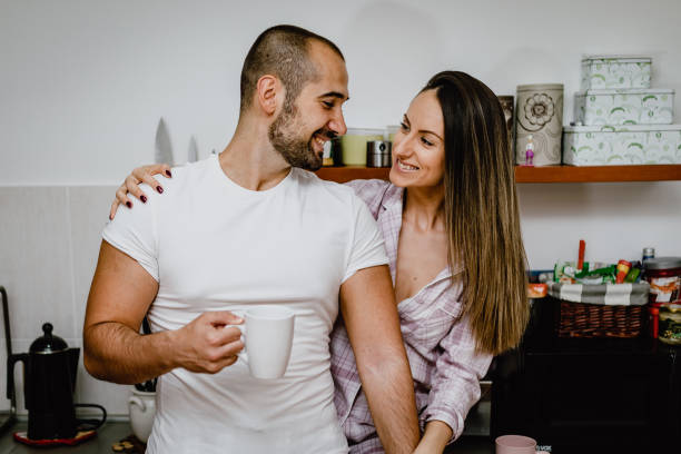 istock Boyfriend and girlfriend drinking coffee and preparing breakfast in the kitchen 1193507772