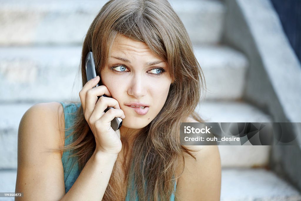 Teenage girl with problems talking by phone  Adult Stock Photo
