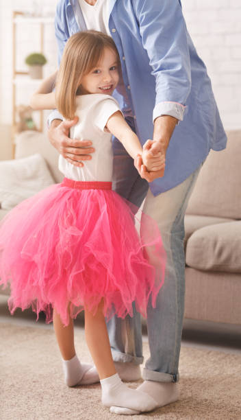istock Daddy teaching little girl dancing at home 1193508732