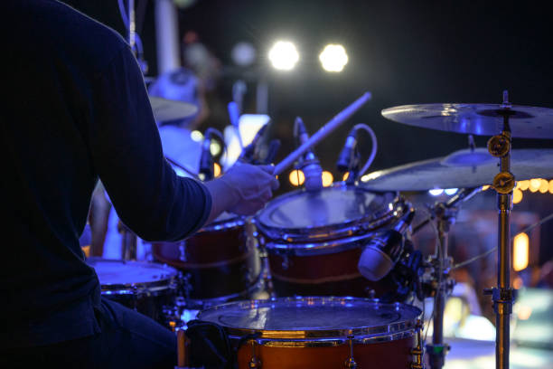 Drummer is playing the drums on stage at the event