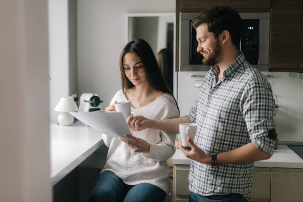 istock Beautiful couple is reading documents. 1193509275
