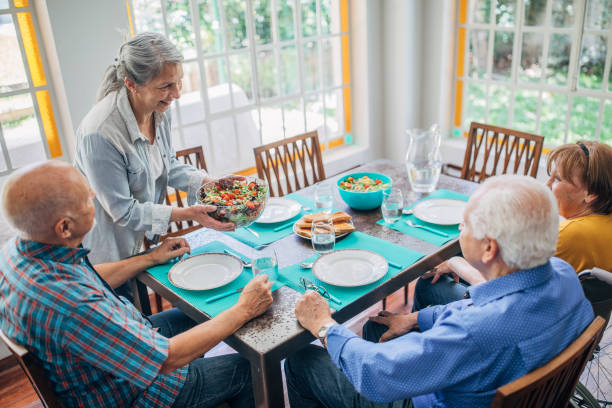 istock Senior people having lunch together at home 1193510598