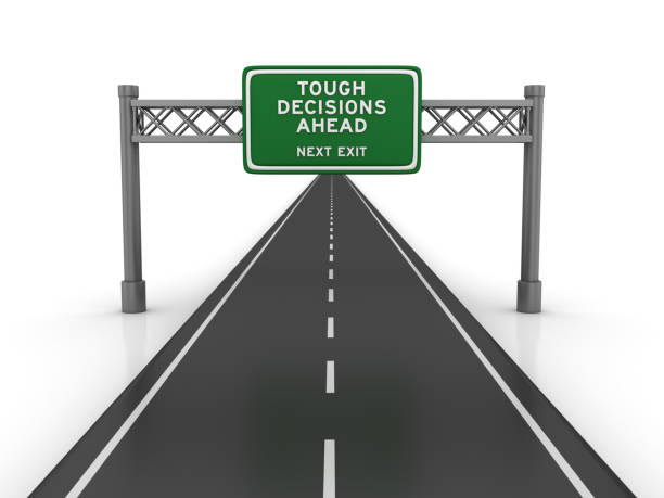 istock Road with TOUGH DECISIONS AHEAD Highway Sign - 3D Rendering 1193510757