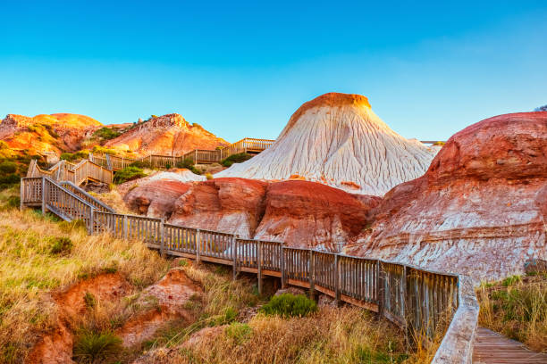 Walking trail with wooden stairs around the Hallett Cove Sugarloaf at sunset Glacial Hike walking trail with wooden stairs around the Hallett Cove Sugarloaf at sunset, South Australia adelaide stock pictures, royalty-free photos & images