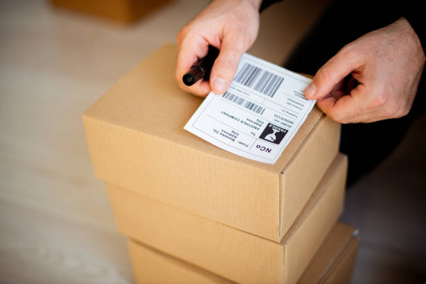 istock Delivery service, applying a shipping labe 1193513475