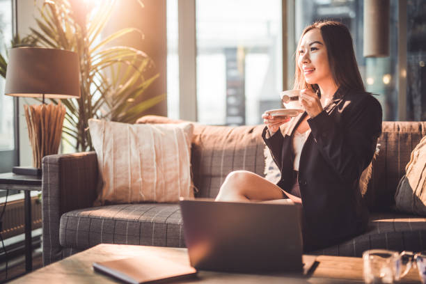 istock Young Asian businesswoman having coffee break. 1193513557