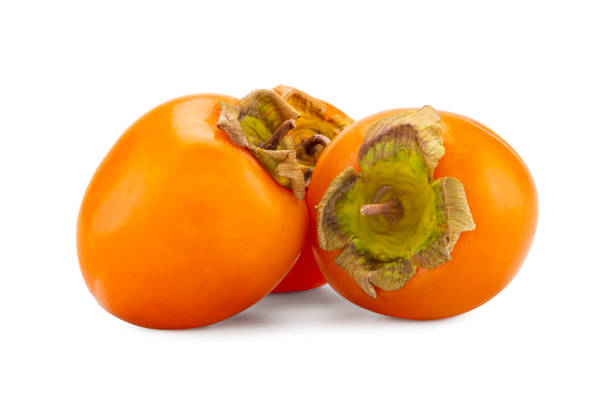 istock fresh ripe persimmons with leaf isolated on white background. full depth of field 1193513617
