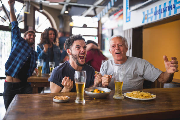 istock Friends watching soccer match 1193513901