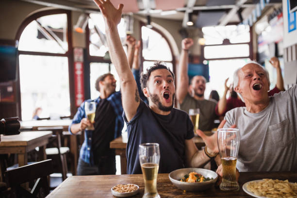 istock Friends watching soccer match 1193513927