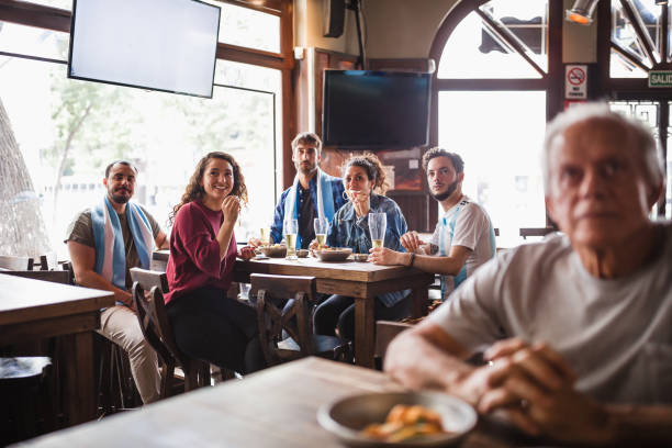 istock Friends watching soccer match 1193513941