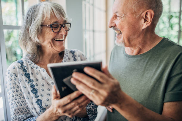istock Senior couple looking at framed picture together 1193514776