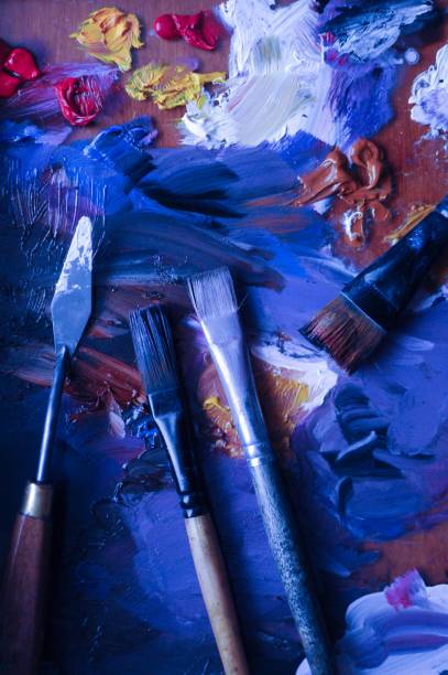istock Flat lay of brushes and paints while drawing on classic blue background 1193515119