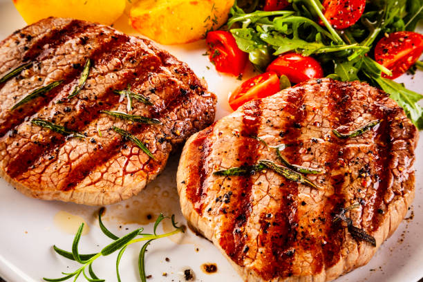 istock Beef steak, fried potatoes and vegetables on white background 1193515215