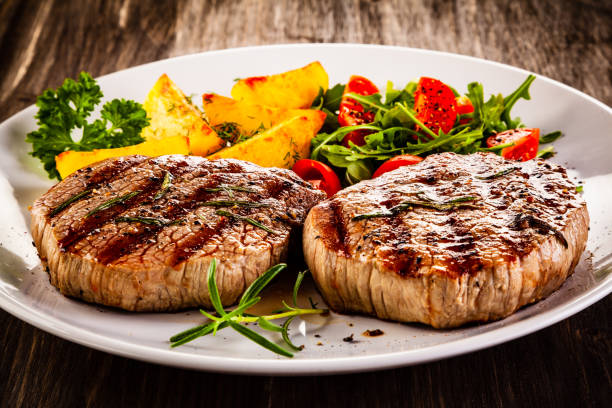 istock Beef steak, fried potatoes and vegetables on white background 1193515279