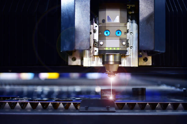 Industrial laser cut machine while cutting the sheet metal industrial Industrial laser cut machine while cutting the sheet metal with the sparking light. laser cutting metal stock pictures, royalty-free photos & images