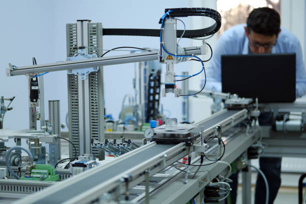 istock Gripper picks up the product from an automated car and programming engineer at the background 1193516621