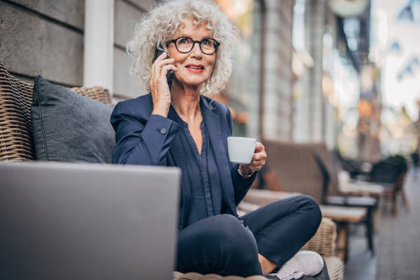 istock Woman talking on mobile outdoors in cafe 1193518148