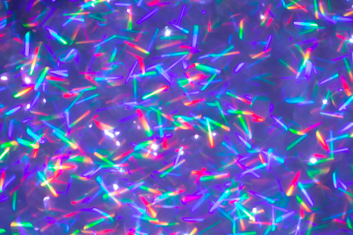 Blurred background with holographic sparkles and lights.