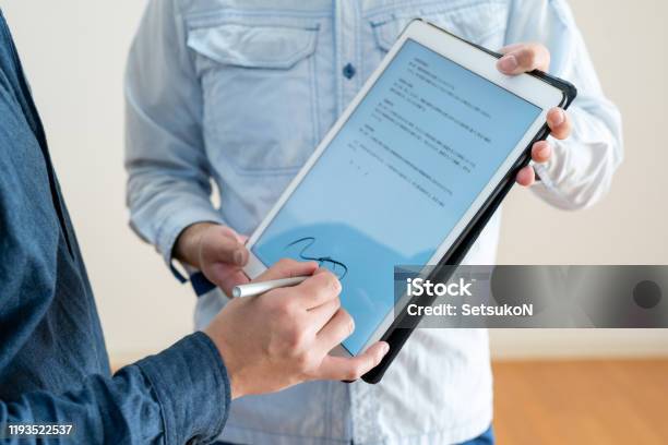 Asian Man Signing Digital Contract On Tablet Closeup Stock Photo - Download Image Now