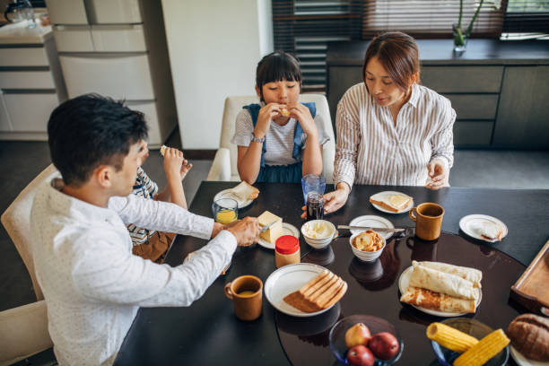 istock Mom and dad having breakfast with children together 1193524483