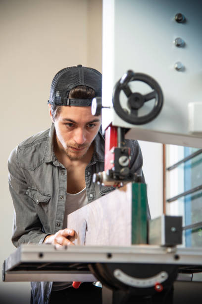 istock Woodworker with belt saw 1193525163