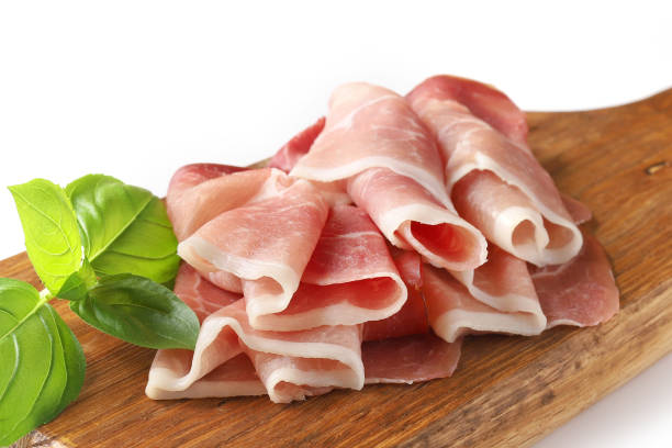 istock prosciutto on wooden cutting board isolated on white background 1193525267