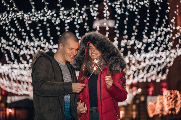 istock Young man and his girlfriend are having fun with sparklers , at night 1193526233