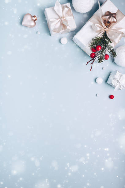 istock Christmas holiday composition, white gift boxes golden Christmas tree decorations on light blue background. Minimalism, flat lay. Copy space 1193526268