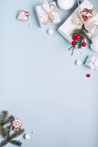 istock Christmas holiday composition, white gift boxes golden Christmas tree decorations on light blue background. Minimalism, flat lay. Copy space 1193526874