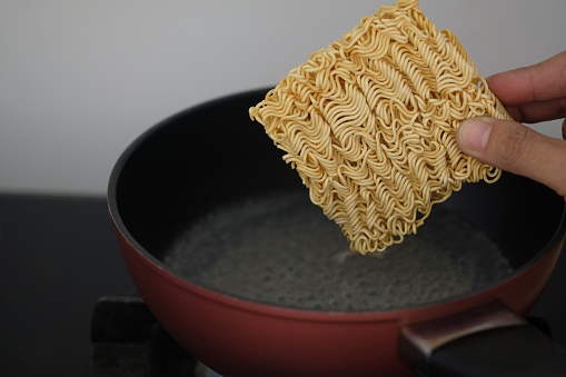 Hand picked instant noodles for put in boiling water pot