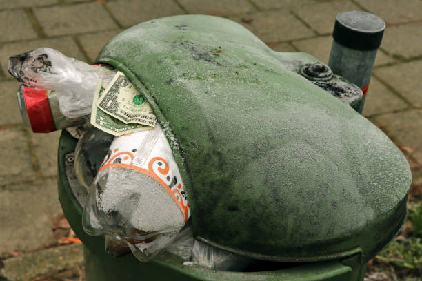 A dollar in the trash with other trash