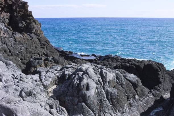 istock Isolated natural pool surrounded by black volcanic rock on the Atlantic Ocean (Seixal, Madeira, Portugal) 1193528307