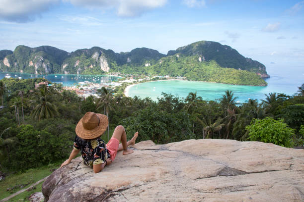 istock Solo traveller, with straw hat, at Phi Phi island viewpoint, Thailand 1193530770