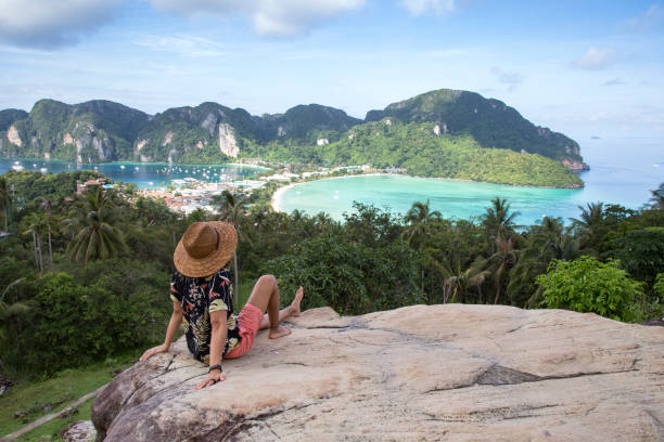 istock Solo traveller, with straw hat, at Phi Phi island viewpoint, Thailand 1193530807