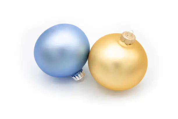 Gold and blue Christmas ornaments on white background