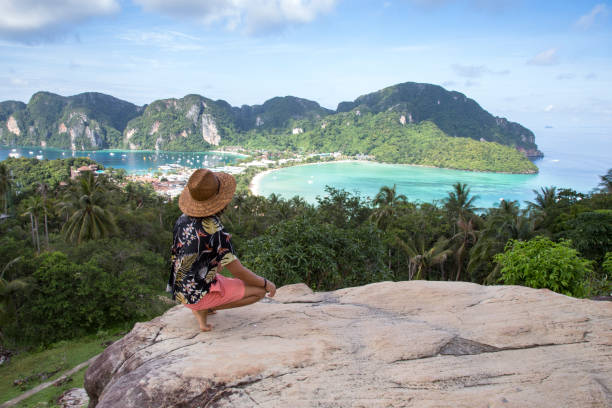 istock Solo traveller, with straw hat, at Phi Phi island viewpoint, Thailand 1193530872